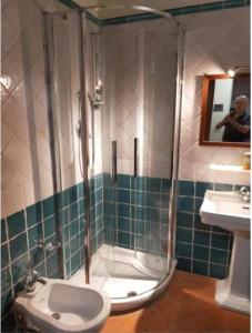 a bathroom with a shower with a toilet and a sink at CASA DI CHIARILU' in Cortona