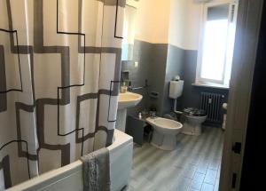 a bathroom with two toilets and a sink at Residenza Monviso in Cuneo
