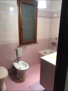 a bathroom with a toilet and a sink and a tub at Villa Circe in San Felice Circeo