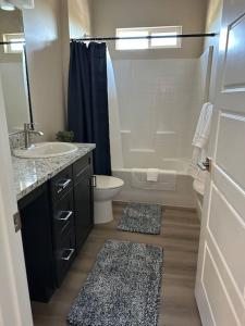 a bathroom with a sink and a toilet and a shower at Grand Canyon-4bed,3bath,hot tub in Hildale