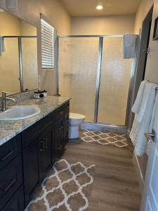 a bathroom with a sink and a shower with a toilet at Grand Canyon-4bed,3bath,hot tub in Hildale