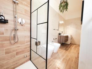 a bathroom with a shower and a toilet at Fortuna Milan - METRO, AC, DUOMO in 25 minutes in Sesto San Giovanni