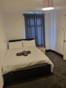 a bedroom with a bed with a stuffed animal on it at Maidstone castle 3bedroom free sports channels, parking in Kent