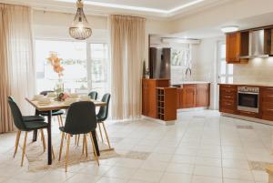 a kitchen with a dining room table and chairs at CITY CENTER VILLA HERSONISOS in Hersonissos