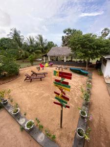 a playground with tables and benches and potted plants at 108 Palms Beach Resort in Trincomalee