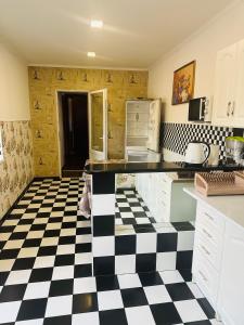 a kitchen with a black and white checkered floor at Private House in Berehove