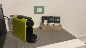a black and green hair dryer next to a box at Acquamarina in Bergeggi