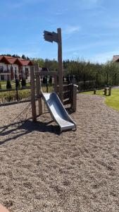 a playground with a slide in a park at Morskie oczko in Żarnowska