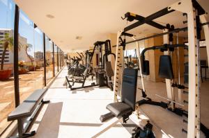 a gym with cardio equipment in a building at Granados Park Hotel in Asunción