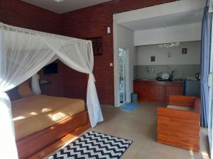 a bedroom with a bed with a mosquito net at Kubu Kawi in Munduk