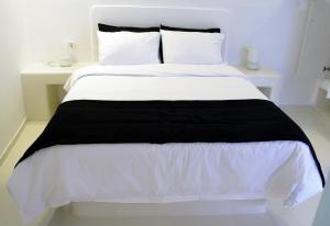 Postel nebo postele na pokoji v ubytování Tataki Family Hotel