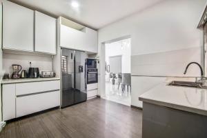 a kitchen with white cabinets and a counter top at Gorgeous Short-let Apartment Lekki in Lekki