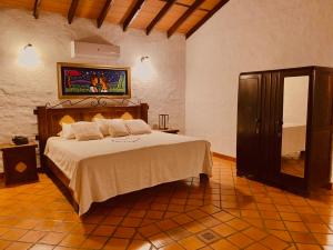 a bedroom with a large bed in a room at KAROBÉ Posada Boutique in San Bernardino