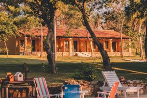 a house with a yard with chairs and a table at KAROBÉ Posada Boutique in San Bernardino