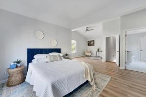 a white bedroom with a blue and white bed at Zen Home in the Heart of Atlanta in Atlanta