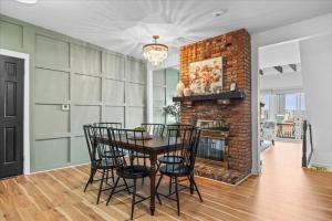 a dining room with a brick fireplace and a table and chairs at Stunning views from stylish 3-bedroom home in Pittsburgh