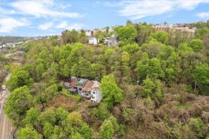 an aerial view of a house on a hill with trees at Stunning views from stylish 3-bedroom home in Pittsburgh