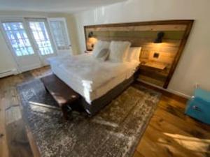 a bedroom with a large white bed with a large mirror at Farm Road Estate in West Dover