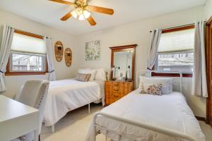 Un dormitorio con dos camas y un ventilador de techo. en Cozy Pocono Lake Cottage with Fire Pit and Ping Pong!, en Pocono Lake