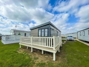a small house sitting on top of a yard at Modern 6 Berth Caravan At Martello Beach In Essex Ref 29002sv in Clacton-on-Sea