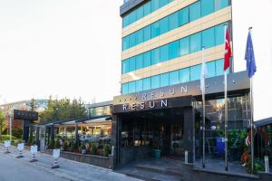 a building with a restaurant in front of it at Resun Hotel in Ankara