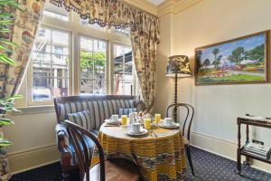 a dining room with a table and a window at Golden Gate Hotel in San Francisco