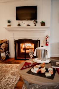 a table with a plate of food and a fireplace at Farm Road Estate in West Dover