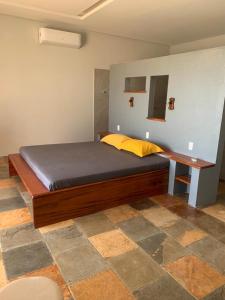 a bedroom with a bed and a desk in it at Vila Kite Lagoon in Parajuru
