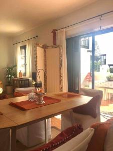 a living room with a table and a large window at Duplex 3 dormitorios con parking privado in Costa Teguise