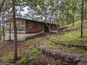 a log cabin in the middle of a forest at Posada San Lázaro in Choluteca