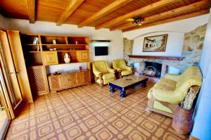 a living room with two chairs and a fireplace at V&V LLORET- VILLA MEDITERRANIA preciosa villa con vistas panorámicas al mar y a solo 120m de la playa Cala Canyelles!! in Lloret de Mar
