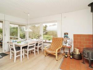 a kitchen with a table and chairs in a room at 6 person holiday home in Nyk bing Sj in Højby