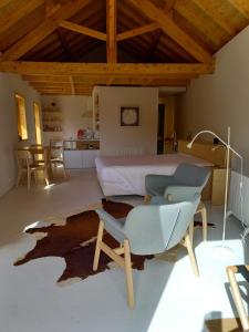 a bedroom with a bed and a chair and a table at Armazém de Sal - Alojamento Loft in Rio Maior