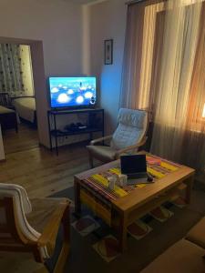a living room with a coffee table and a tv at TOON 94 in Dilijan