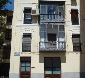 un edificio alto con ventanas y balcones en Hostal Central Zaragoza, en Zaragoza