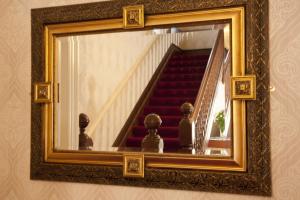a mirror on a wall with a staircase in it at Denewood Hotel in Bournemouth