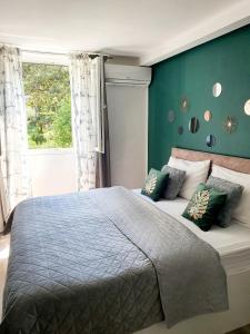 1 dormitorio con 1 cama grande y pared azul en Batala1-City marina apartment with secured private parking en Dubrovnik