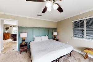 a bedroom with a bed and a ceiling fan at New Kids On The Dock in Destin
