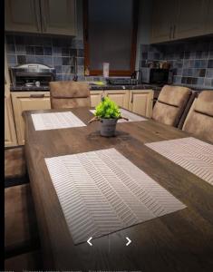 a kitchen with a wooden table with a plant on it at Keystone Villas in Kolašin