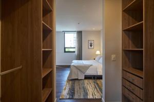 a bedroom with a bed and a large closet at Caluce Apt 2A by Letoh in Chía