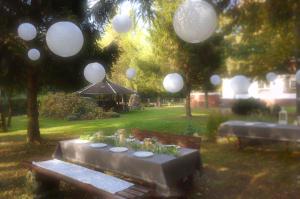 a group of paper lanterns hanging over a park bench at Marysieńka in Kwatoniów +1 photo