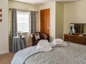 a hotel room with a bed with towels on it at Trem Y Werydd in Amlwch