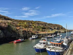 a group of boats are docked in a harbor at Trem Y Werydd in Amlwch