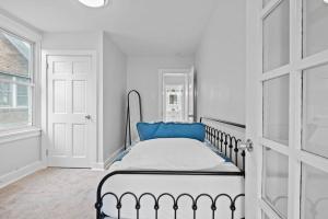 een slaapkamer met een bed met een blauw kussen erop bij Charming 3-Bedroom Home Near Downtown Free Parking in Pittsburgh