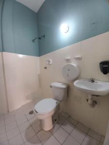a bathroom with a toilet and a sink at Chante in Puerto Escondido