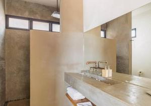 a bathroom with a sink and two faucets at Chateaux del Valle Vacational Homes in Valle de Guadalupe