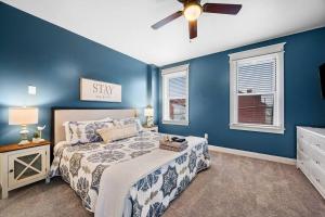 a blue bedroom with a bed and a ceiling fan at NEW! High-end Manchester Home w/ a hot tub in Pittsburgh