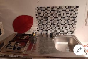 a kitchen with a stove and a sink at L' Eau'thentique in Bouillante