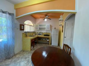 a kitchen with a wooden table in a room at Casa Maiana in Sámara