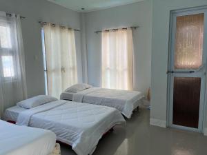 Katil atau katil-katil dalam bilik di Exclusive Beach Resort Rental - Baler